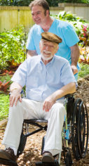 caregiver and an elderly in a wheel chair